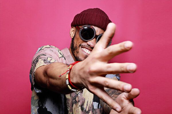 An image of singer Anderson Paak with his arms reaching out towards the camera